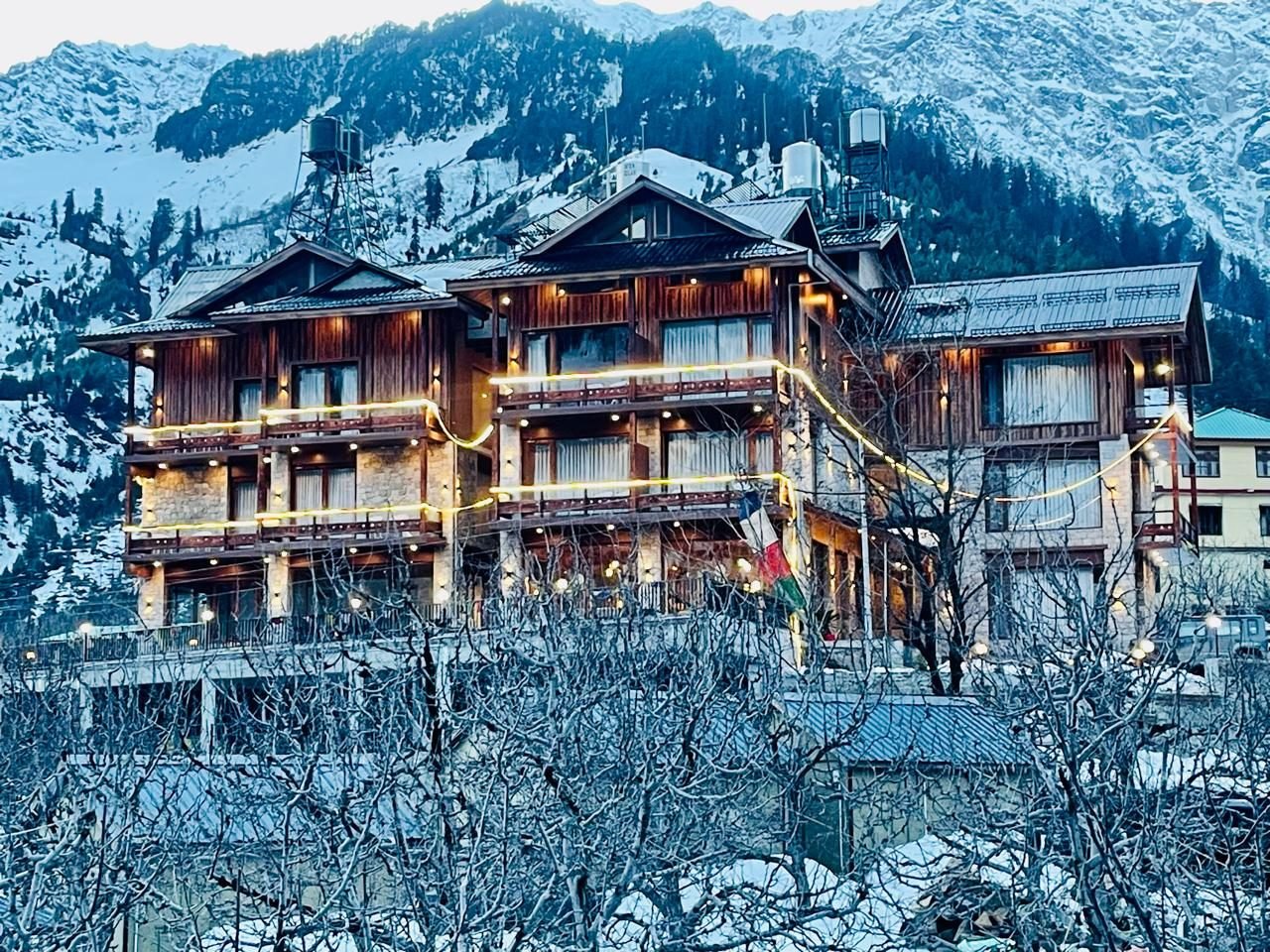 The house lit up on a snowy evening