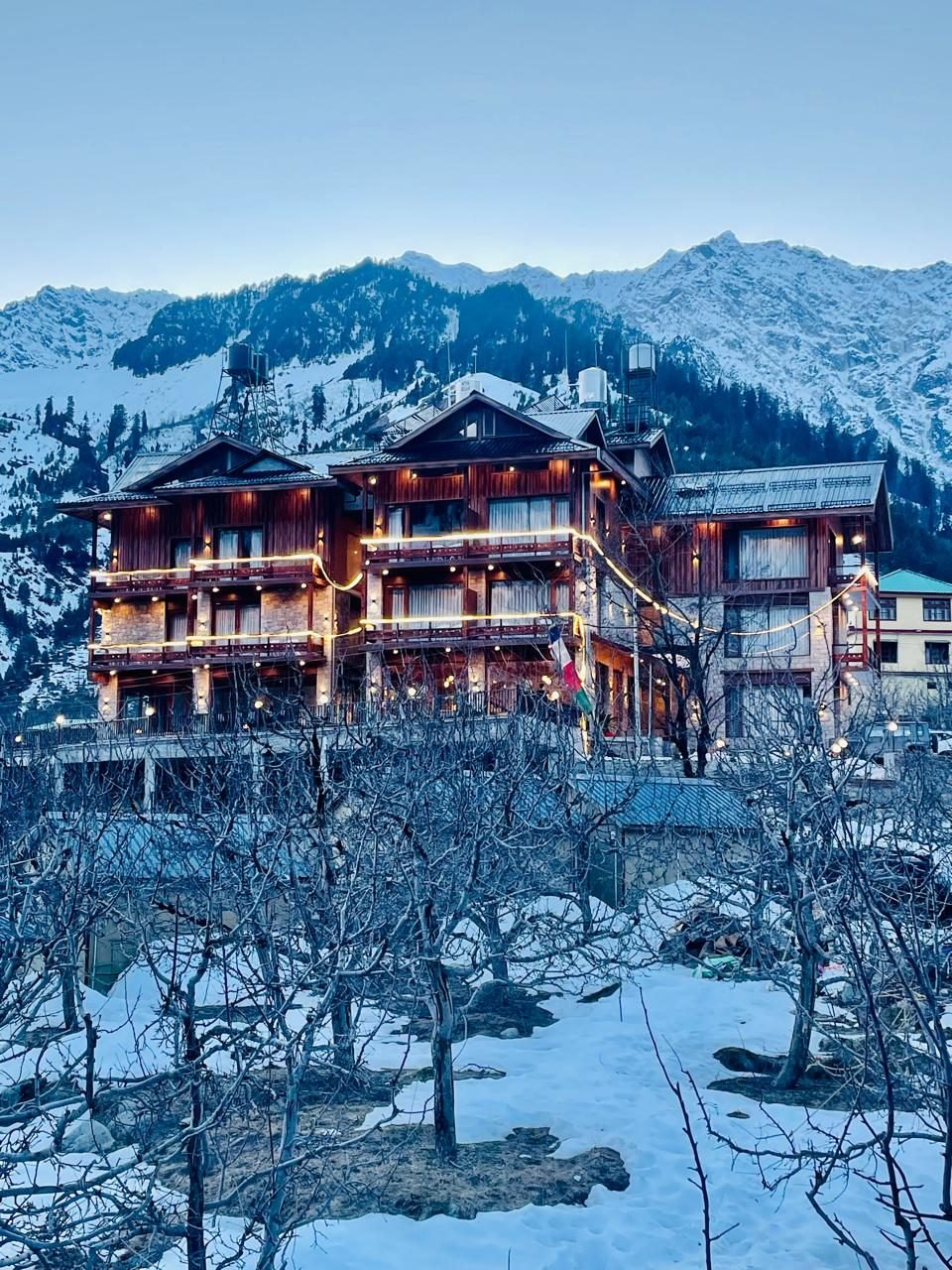 Rigzin House in snow, lights on
