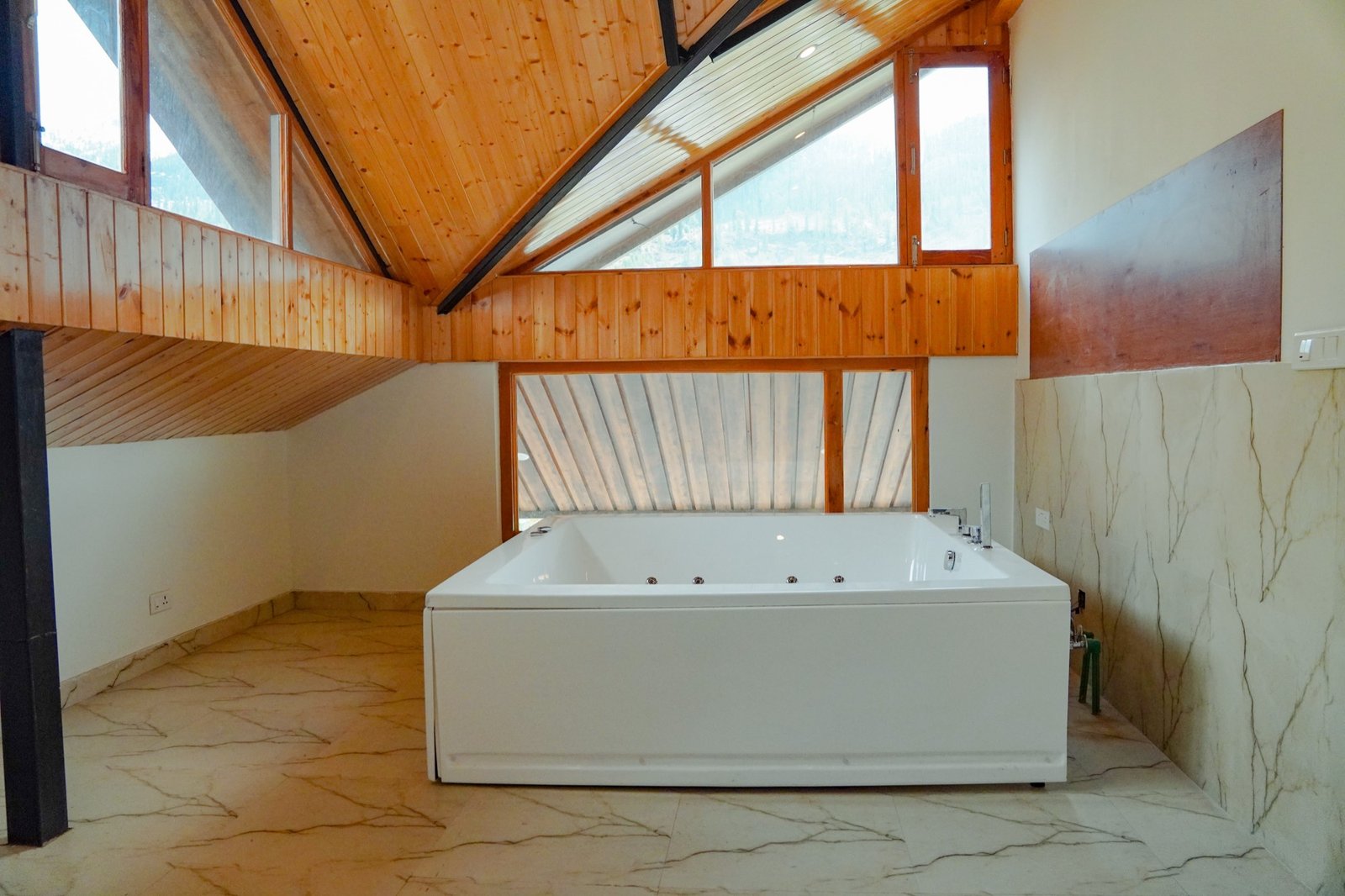 Jacuzzi bathtub under the attic skylight